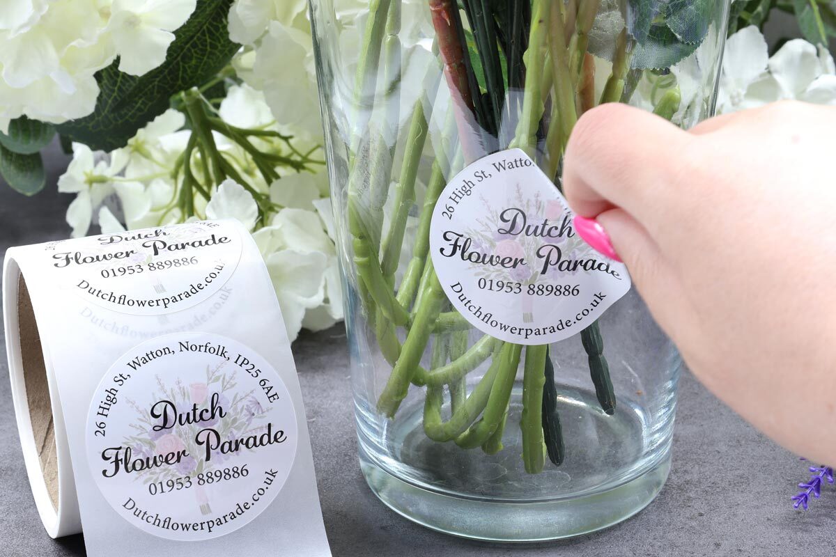 Removable labels being peeled off vase