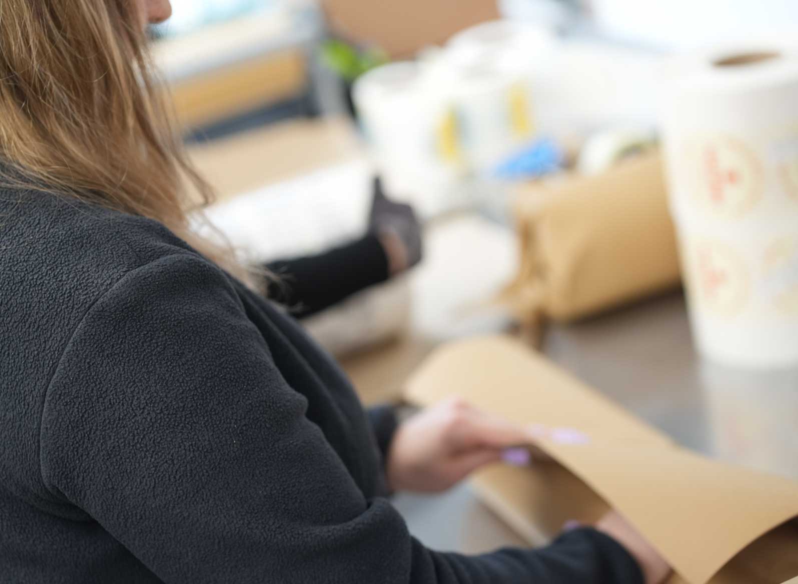 Packing a roll of bespoke labels at FastLabels dispatch